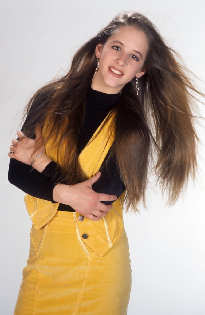 Teenage girl posing for photo in yellow dress