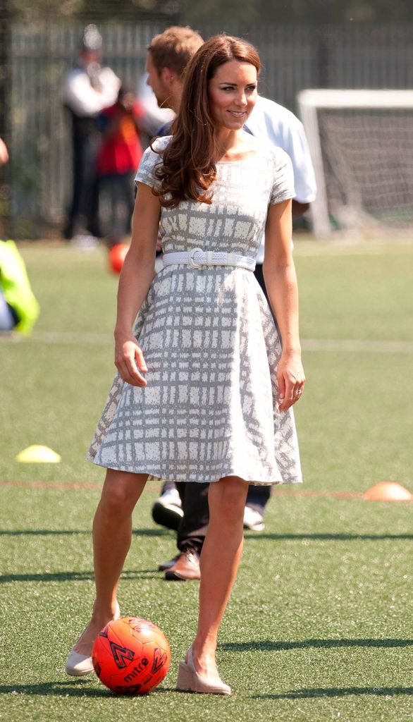Princess Kate playing football in a dress