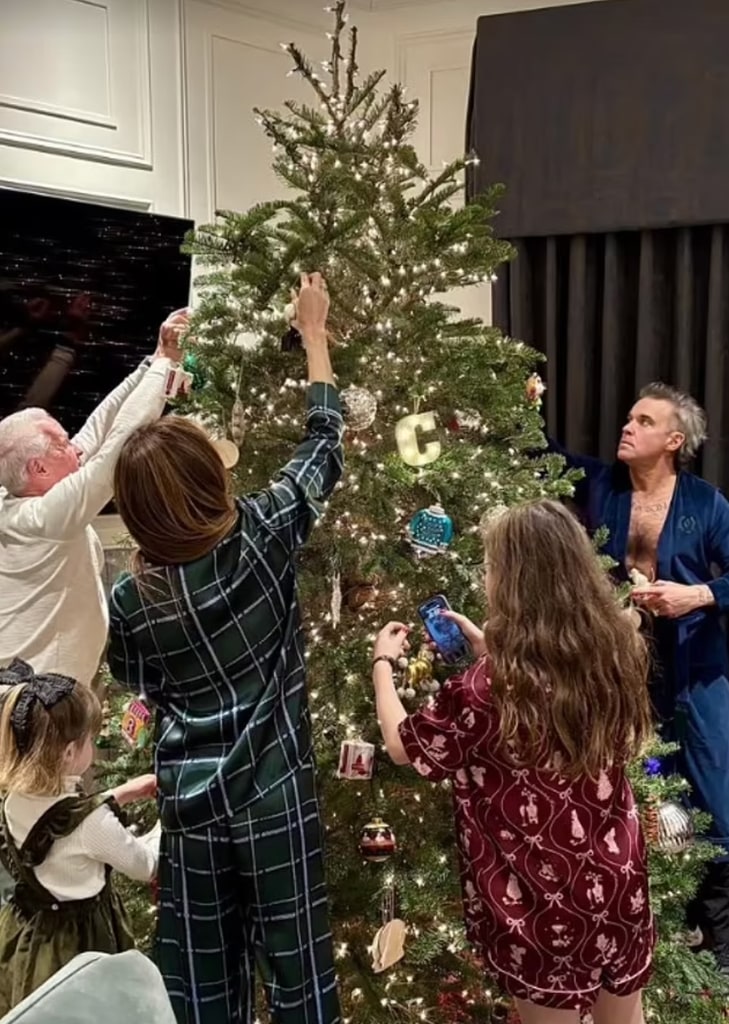 The family came together to decorate the towering tree