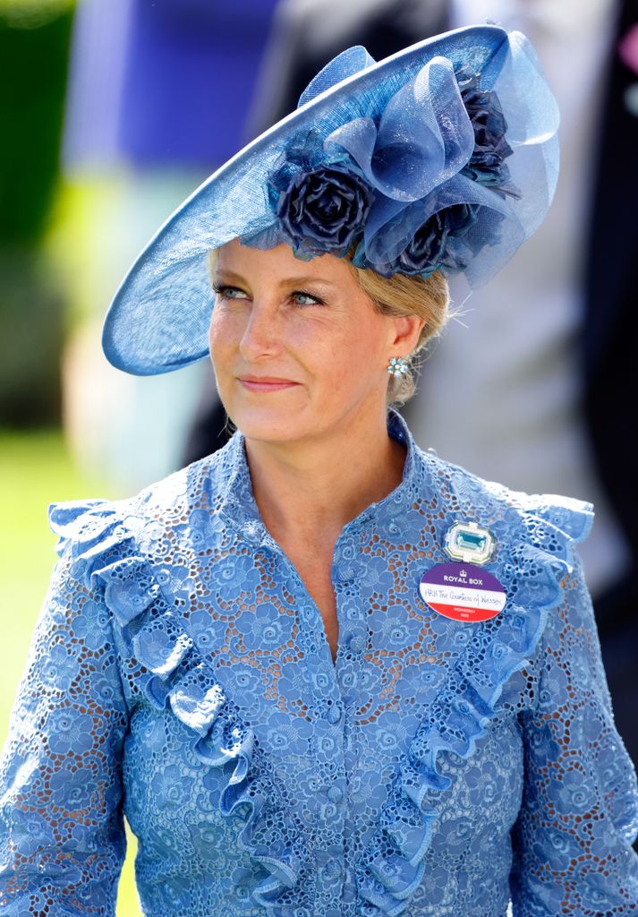Sophie in blue lace dress and floral hat