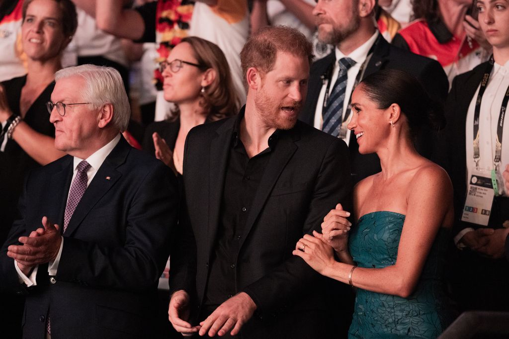 Prince Harry and Meghan Markle standing next to German President Frank-Walter Steinmeier 