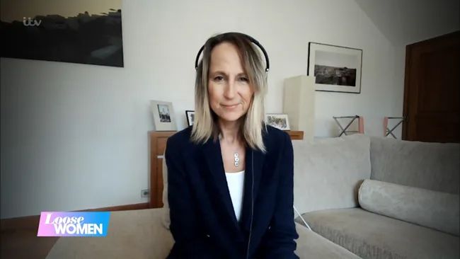 carol mcgiffin with headphones on in lounge
