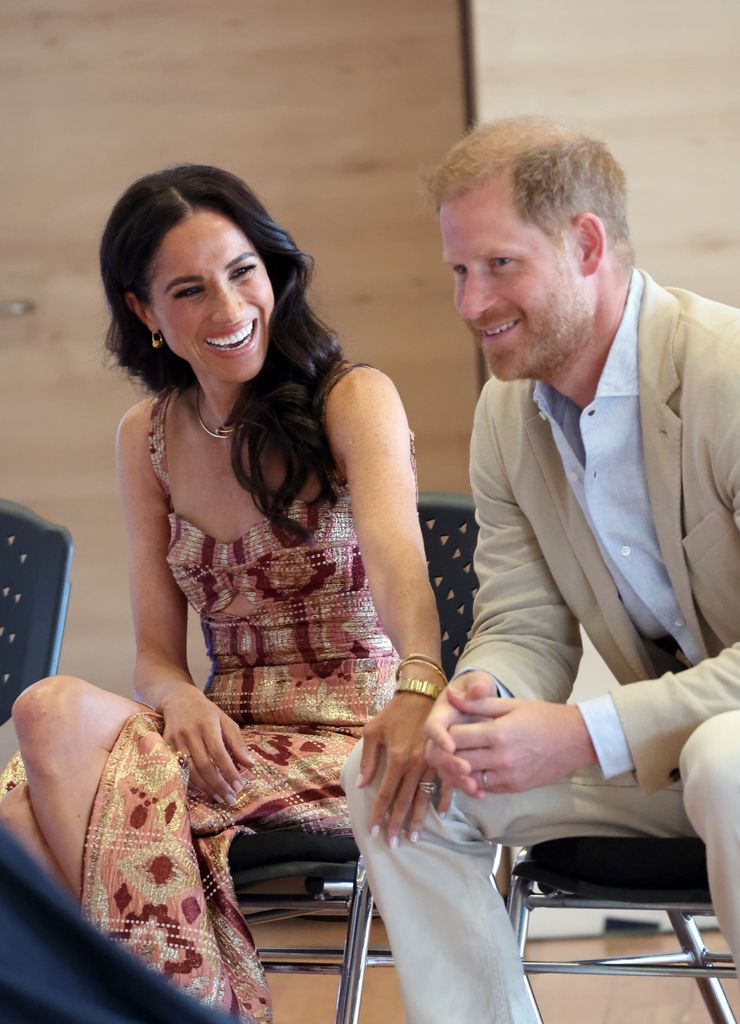 Meghan, Duchess of Sussex laughing looking at Prince Harry who looks unsure