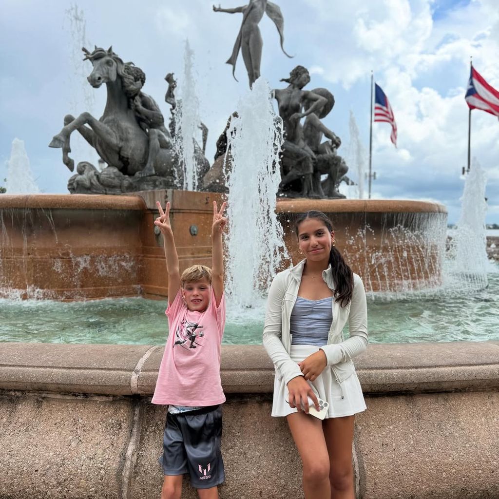 Eric and Roselyn's kids are adorable posing by fountain