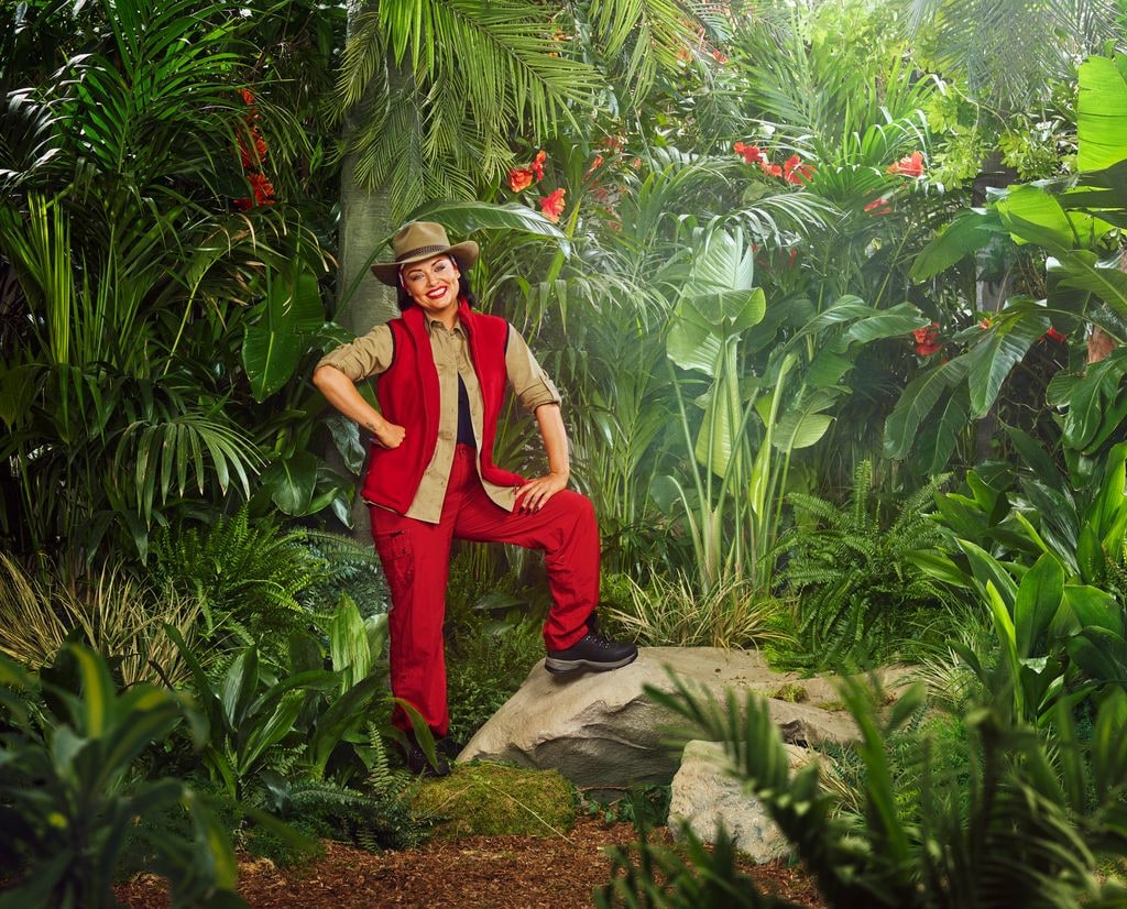 person in red and beige uniform in jungle setting