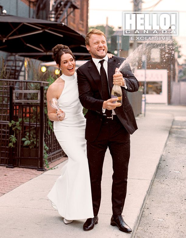 Tessa Virtue and Morgan Rielly spraying champagne at their wedding
