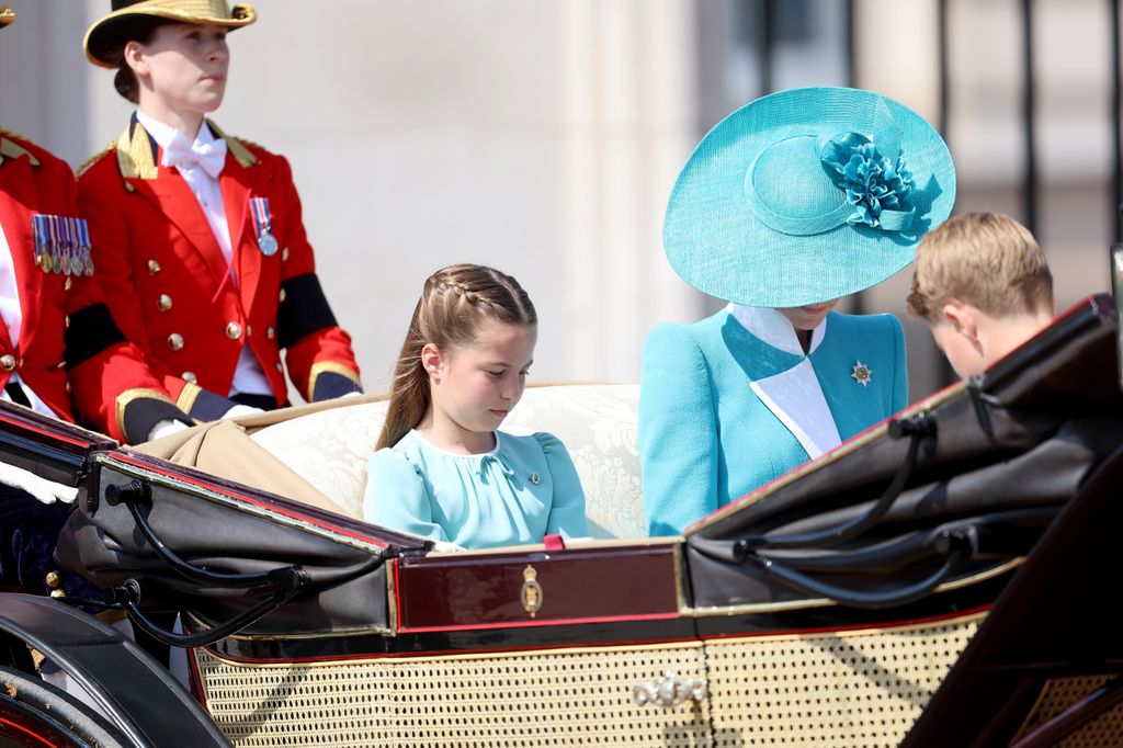 Princess Charlotte, the Princess of Wales and Prince George bow during the National Anthem