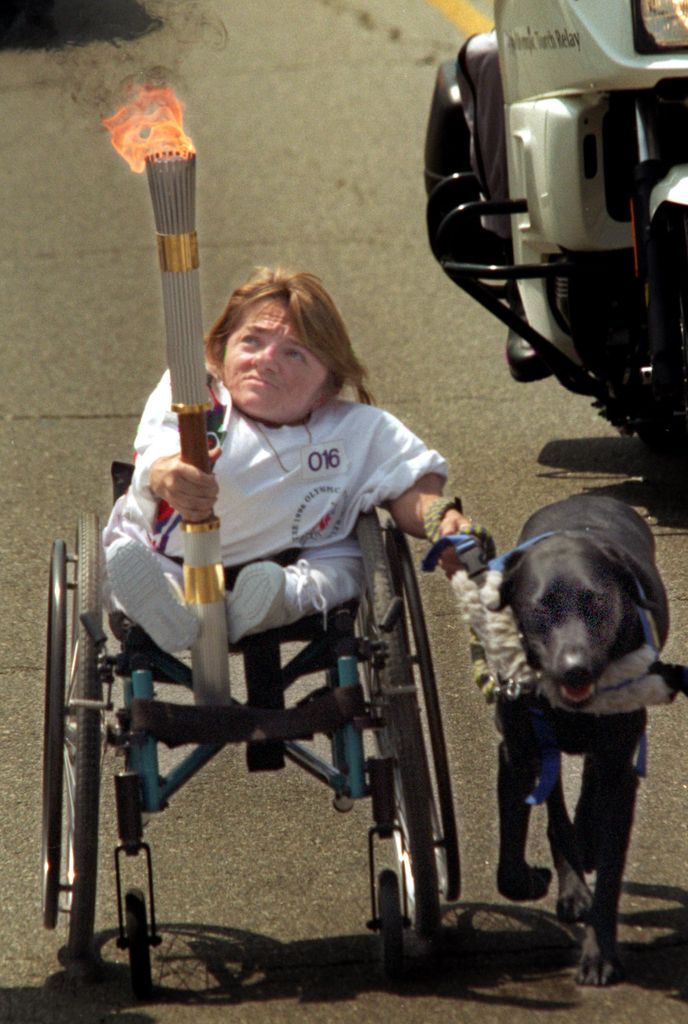 Melanie with her dog "Roamer," during the first day of the cross country Olympic Torch Relay