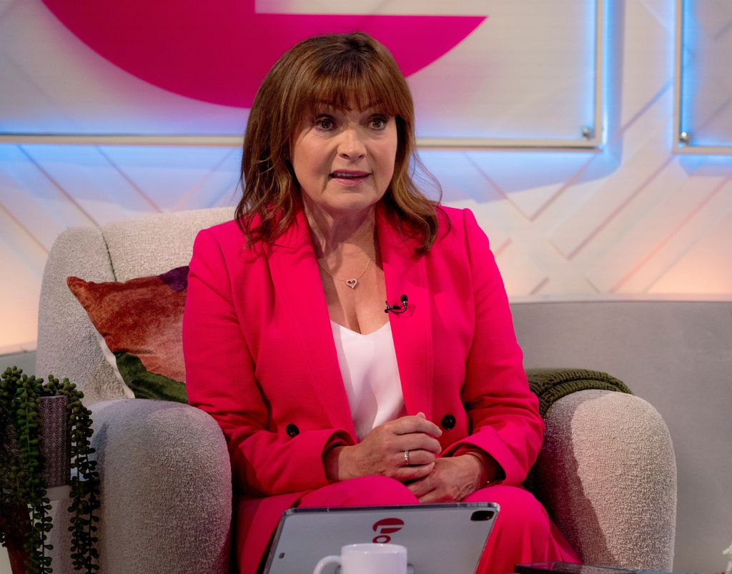 Lorraine Kelly in a pink coat at her fashion show