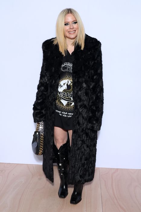 Avril Lavigne in knee high boots at Paris Fashion week