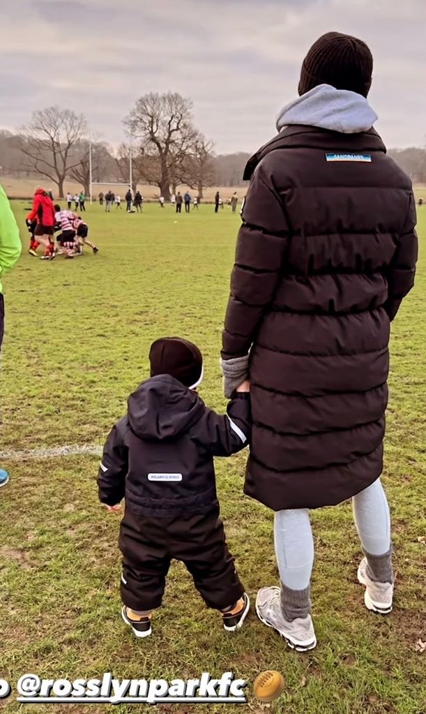 Frida Redknapp watching rugby with her two-year-old son Raphael
