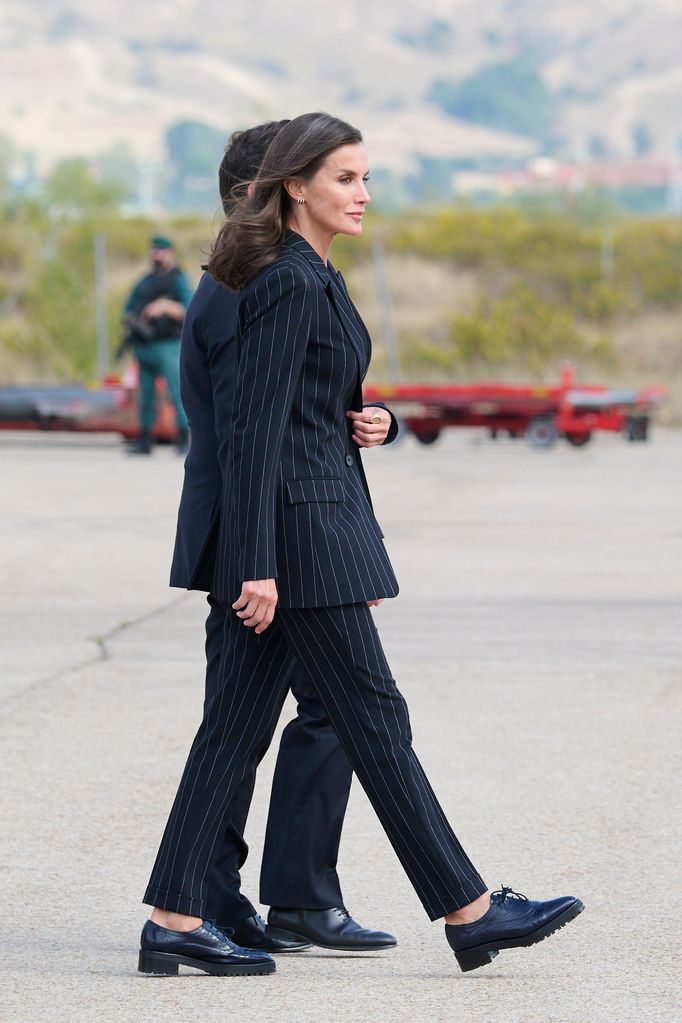 Queen Letizia on runway walking in suits and in stylish Oxfords