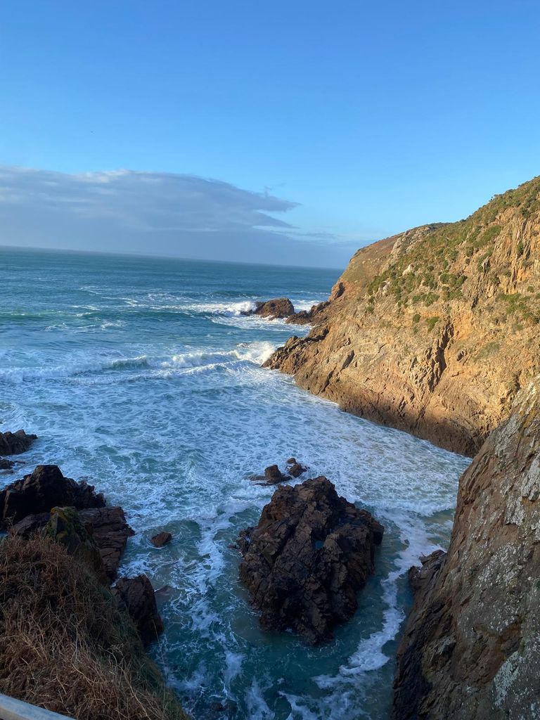 Cliffs and choppy sea under a blue sky