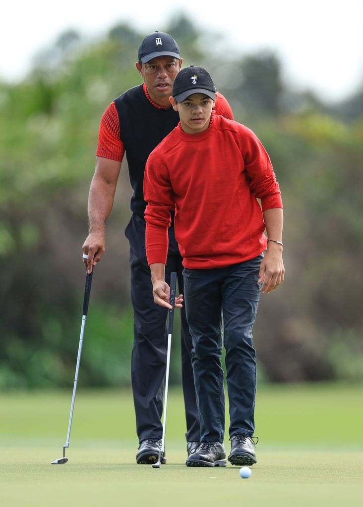  Tiger Woods of The United States lines up a putt with his son Charlie Woods on the third green during the final round of the 2022 PNC Championship at The Ritz-Carlton Golf Club on December 18, 2022 in Orlando, Florida. 