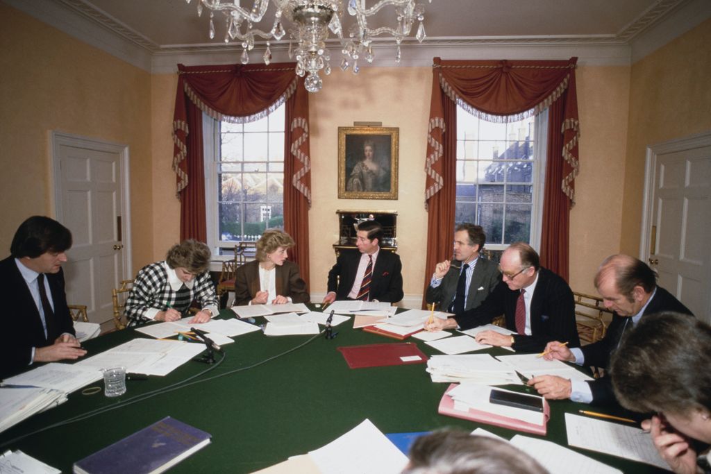 Diana, Princess of Wales and her husband, Charles, Prince of Wales, with advisors during a planning meeting in the dining room of Kensington Palace, London