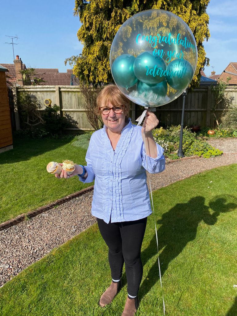 woman holding a retirement balloon