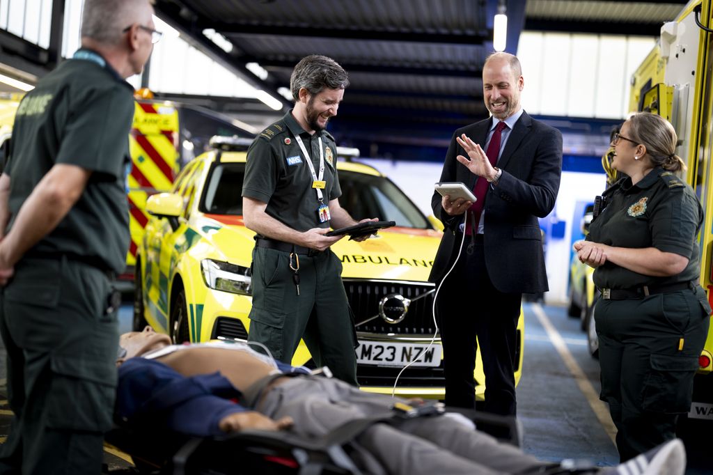 The Prince of Wales takes part in a training demonstration during a visit to the London Ambulance Service