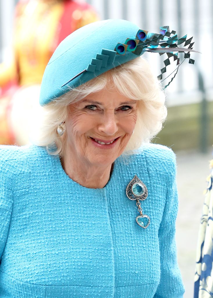 Queen Camilla in a teal outfit