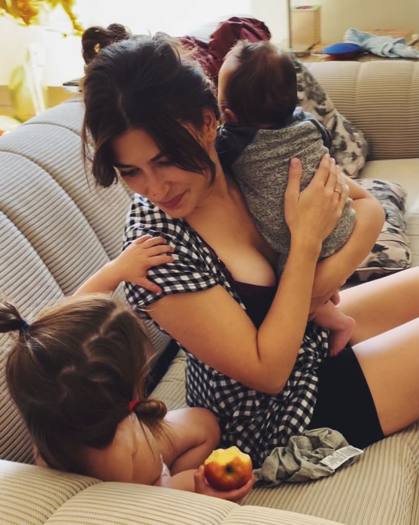 jazz charton holding baby sitting on couch with daughter