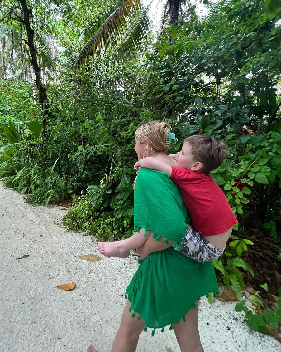 Tilly Ramsay  in a green kaftan as she carried her baby brother Oscar