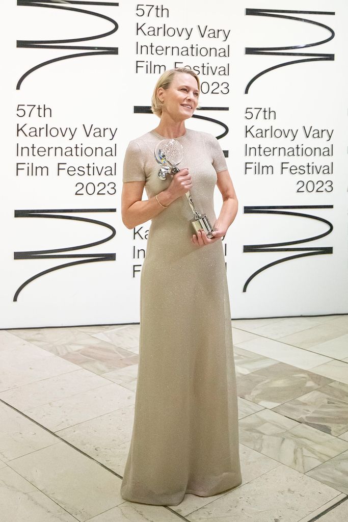 Robin Wright poses for a photo after she recieved the Crystal Globe for the Festival President's Award from the President of the festival Jiri Bartoska during the closing ceremony of the 57th Karlovy Vary International Film Festival on July 08, 2023 in Karlovy Vary, Czech Republic. The annual Karlovy Vary International Film Festival is the largest film festival in the Czech Republic.
