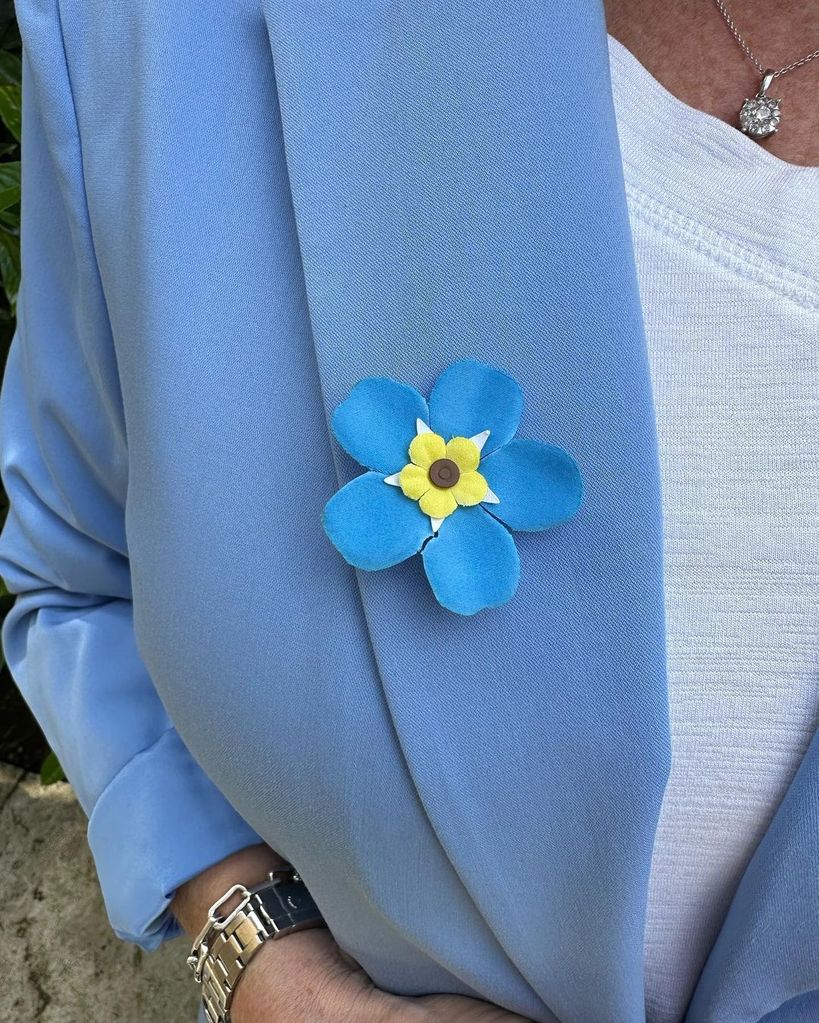 Ruth Langsford wearing a Forget Me Not badge in honour of her dad