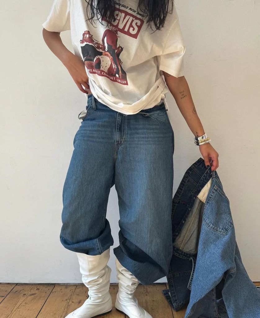Olivia Pezzente wearing jeans, white t-shirt and white boots