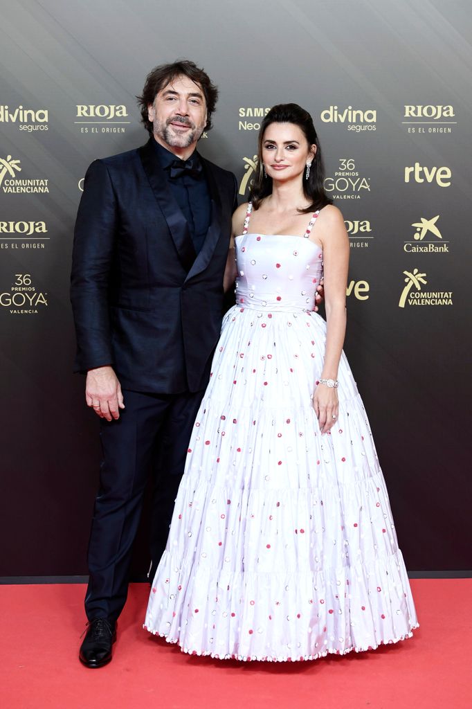 Javier Bardem on the left in a suit and Penelope Cruz on the right in a spotty dress