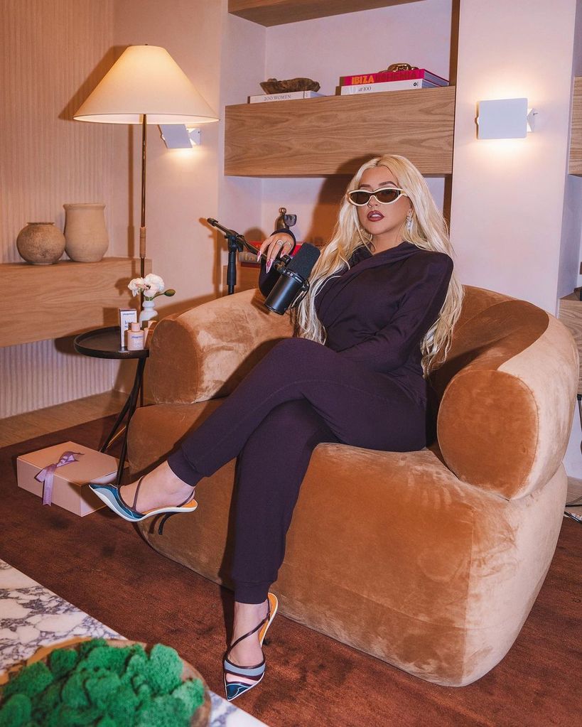 Christina Aguilera wearing all black and sunglasses