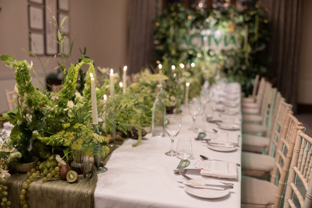 Table with greenery and candles running down the middle