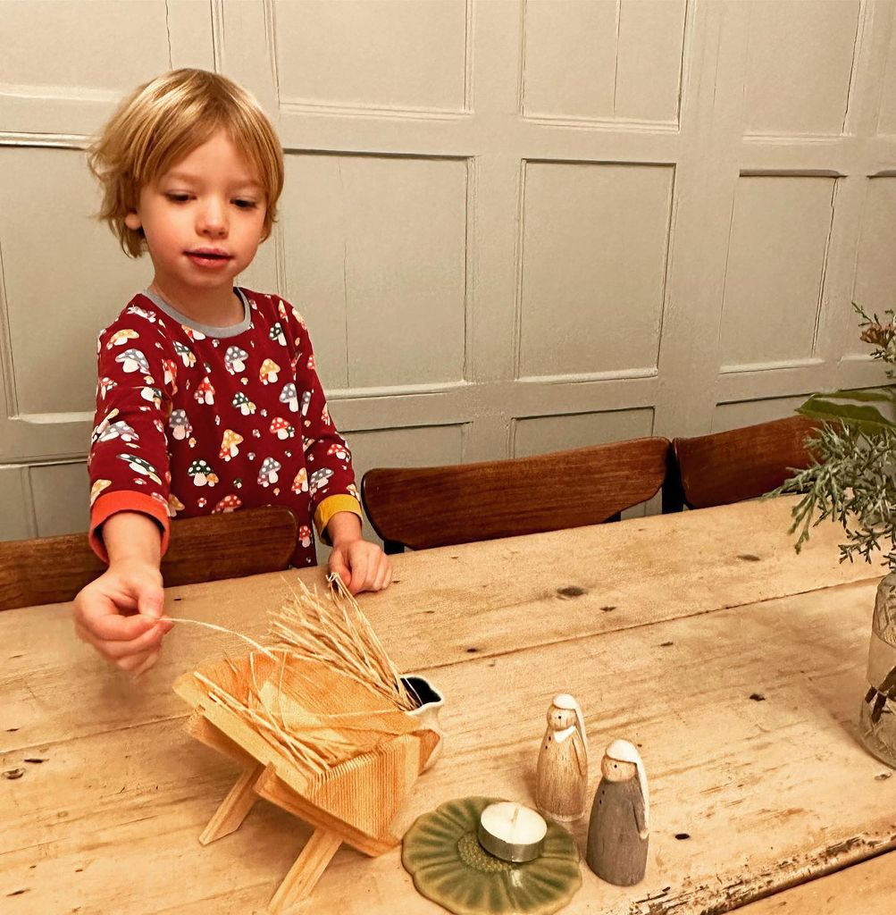 jamie's son in dining room with wood-panelled walls