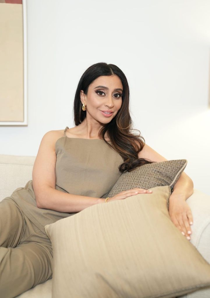 beautiful woman with dark hair posing with pillows 