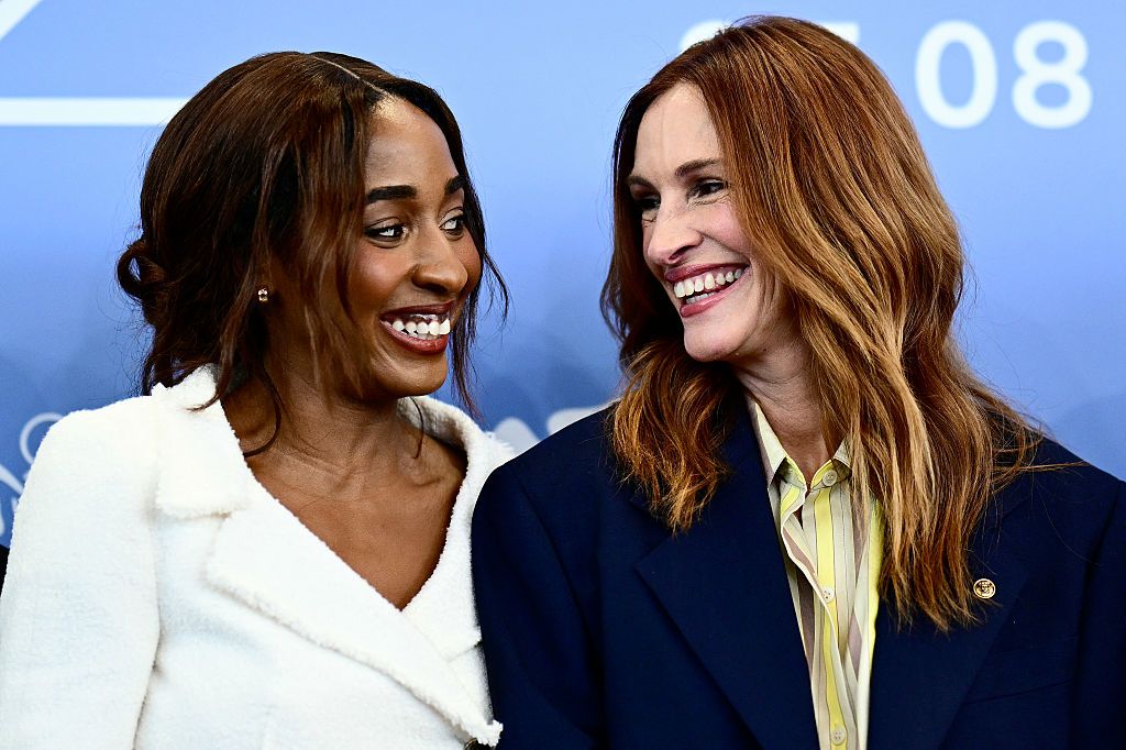Julia roberts and Ayo Edebiri smiling at each other 