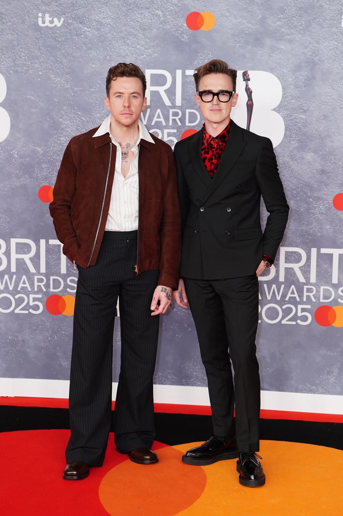 two men posing at brit awards 