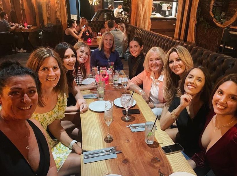 A group of women sat around a table at a restaurant