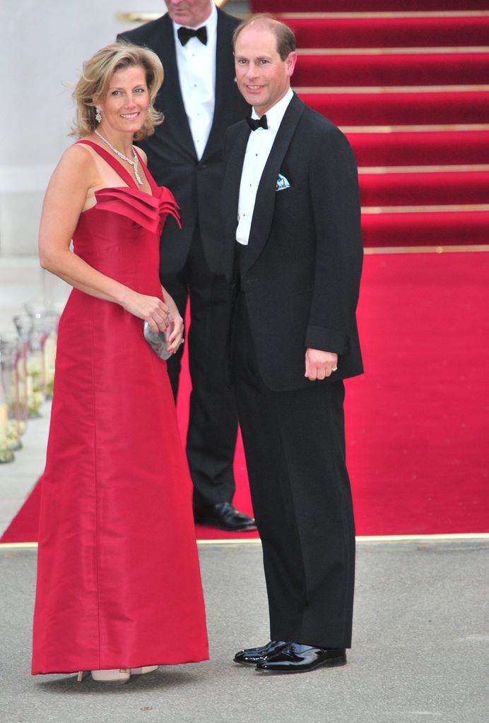 Sophie Wessex in a red dress smiling next to her husband