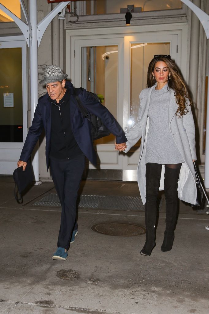 George Clooney and his wife Amal Clooney hold hands as they head out together in New York.