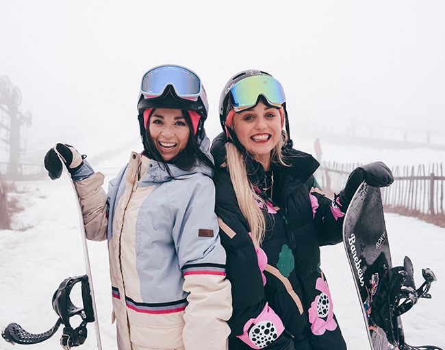 Katya Jones and Aimee Fuller pose with snowboards