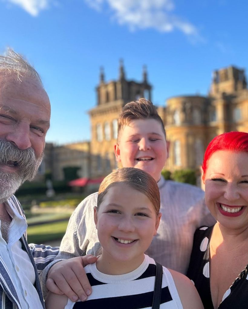 family of four posing in front of blenheim palace