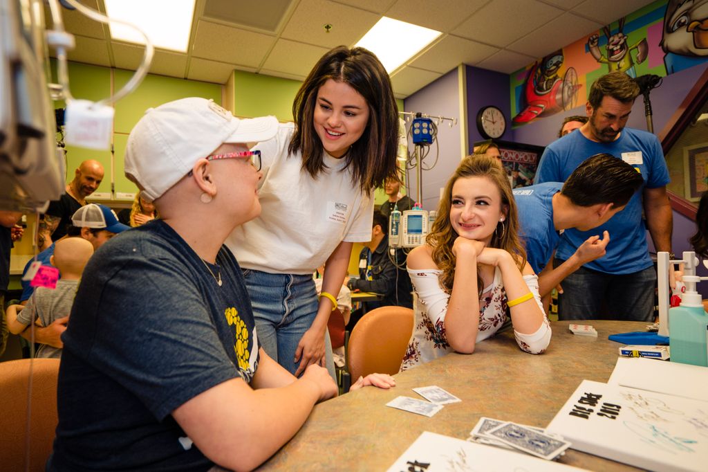  Selena Gomez takes a photo with patients and families at Children's Mercy Hospital during the Big Slick Celebrity Weekend 