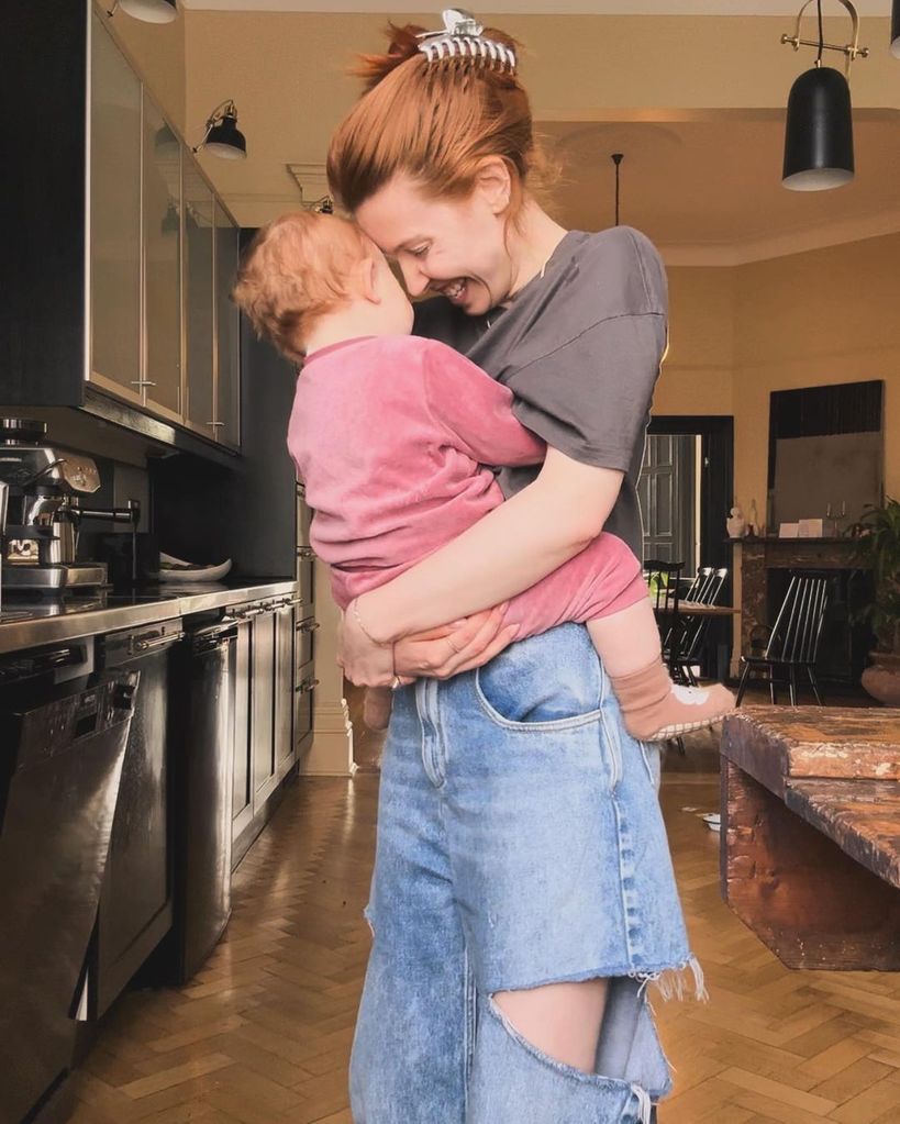 Stacey Dooley holding Minnie in the kitchen