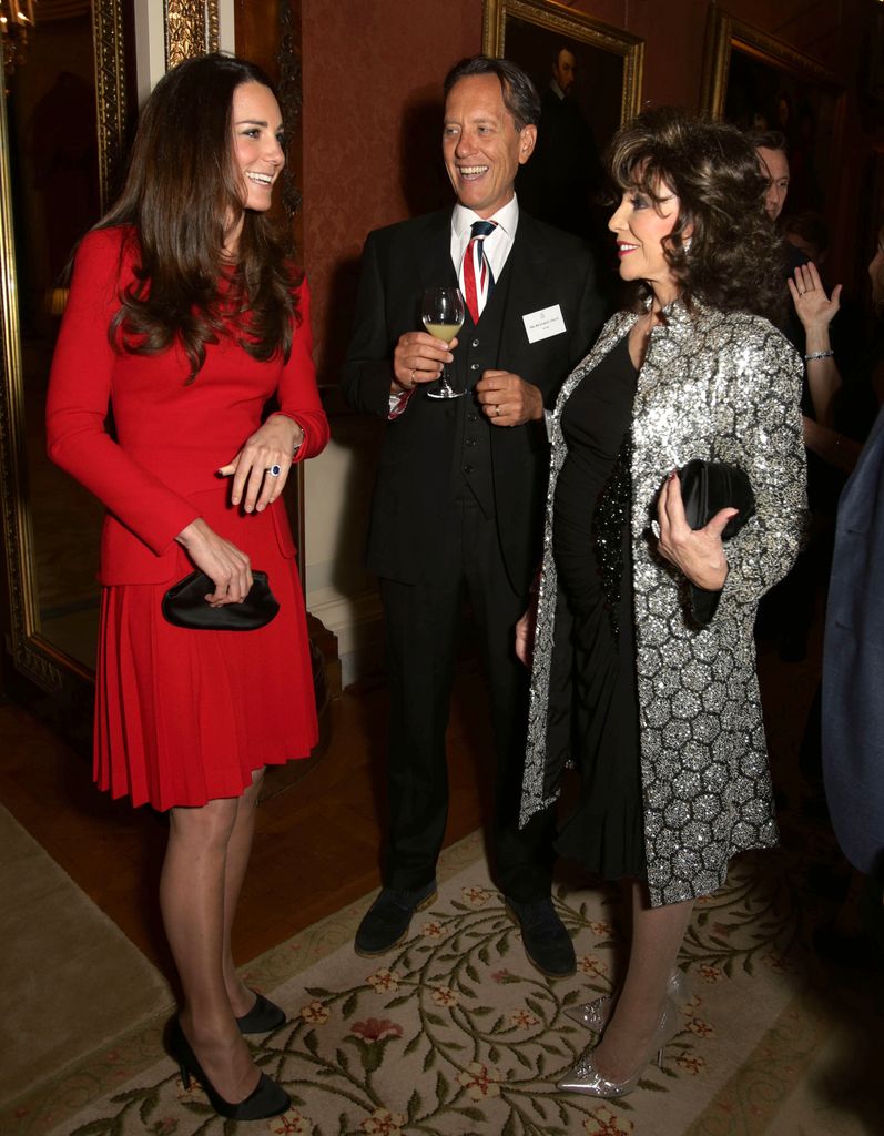 Britain's Catherine, Duchess of Cambridge (L) meets British actress Joan Collins