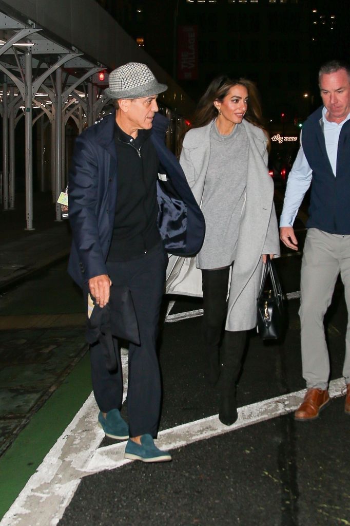 George Clooney and his wife Amal Clooney hold hands as they head out together in New York.