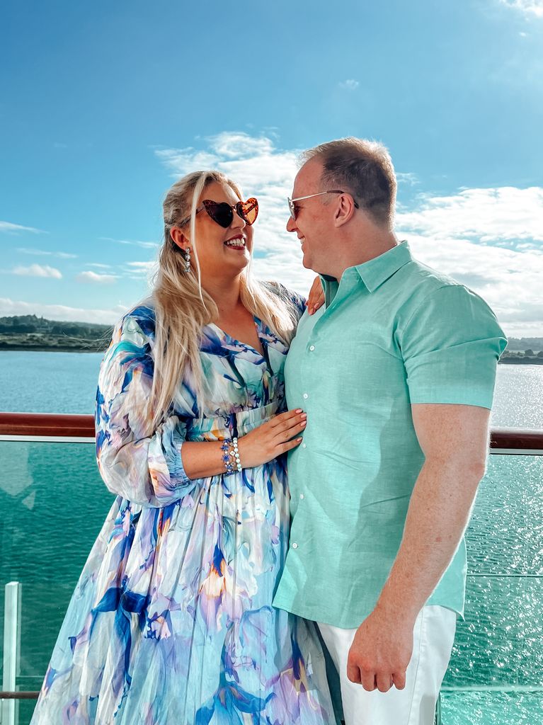 Man and woman gazing at each other with the sea in the background 