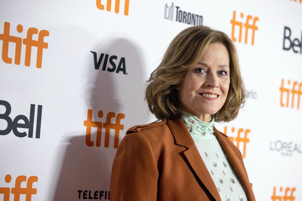 sigourney weaver orange jacket
