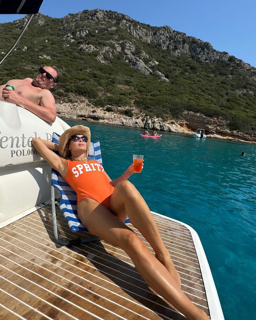 Alan Carr and Amanda Holden lounging on a boat