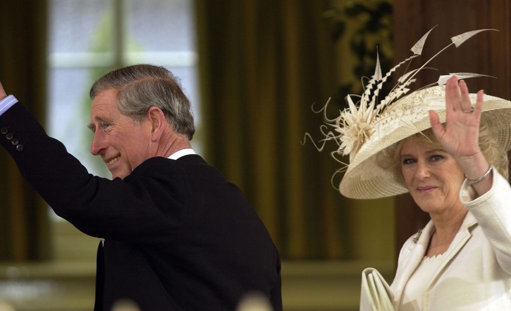 King Charles and Queen Camilla waving at their royal wedding