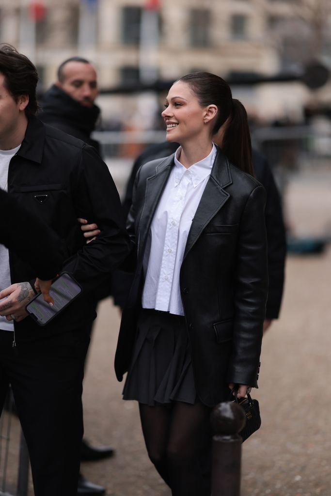 PARIS, FRANCE - MARCH 07: Nicola Peltz seen wearing a black leather jacket, a white blouse, a mini skirt, a black bag and black transparent tights before the Miu Miu show on March 07, 2023 in Paris, France. (Photo by Jeremy Moeller/Getty Images)