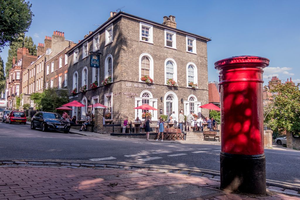 London, August, 2018 A Traditional Old English Pub And Red post box in Hampstead