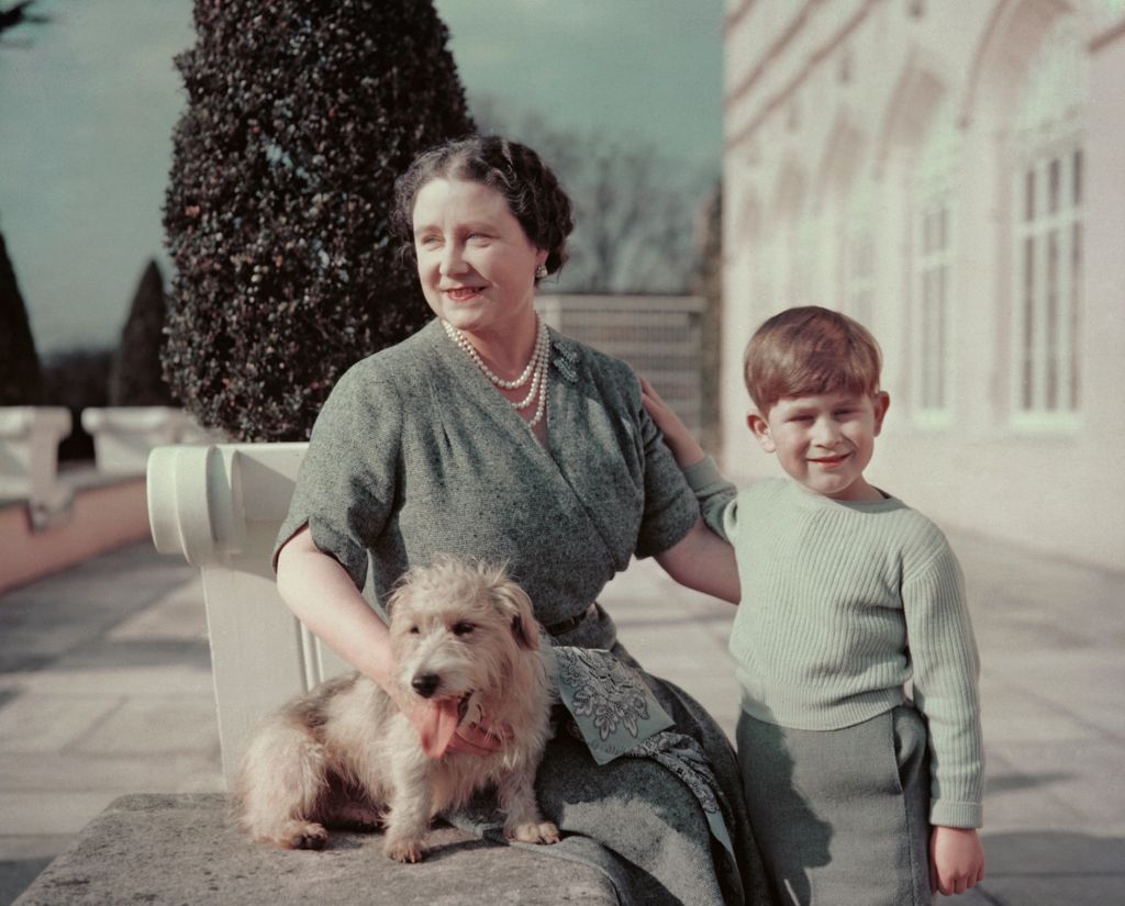 The Queen Mother, wife of George VI, with her grandson Charles and Pippin the dog 